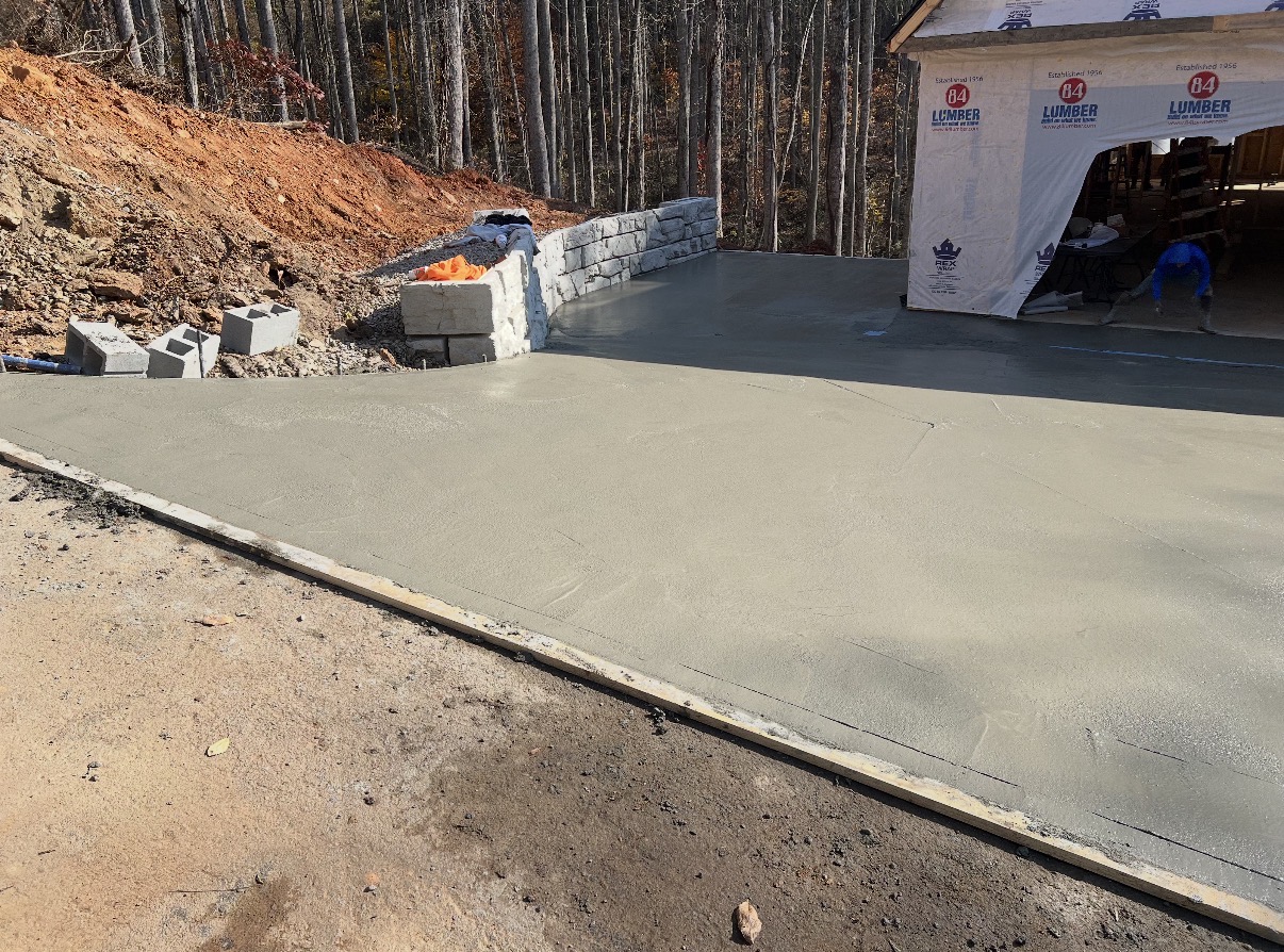 Freshly poured, finished concrete slab pad on a job site